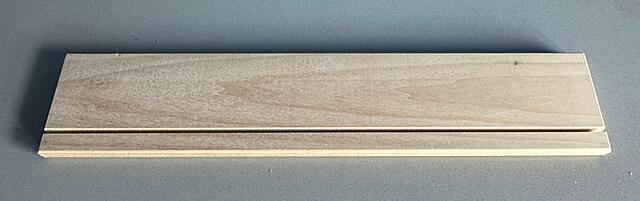 Sign holder that is just a piece of poplar with an 8mm groove cut in it at a 15 degree angle.