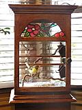 close-up of the canary cage. 
The front is glass and the back is plexi-glass.