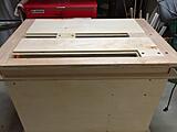 In this picture of the top, you can see the slots where the clamp blocks ride. You can see one roughly left of center in the far slot, and one right up against the end of the slot in the lower one.