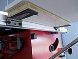 Out feed table attached to my rear rail with hinges.  Used roofing felt as a buffer between metal hinge & alum rail.
