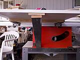 The arm is also attached with a hinge so the table can be folded down when not needed